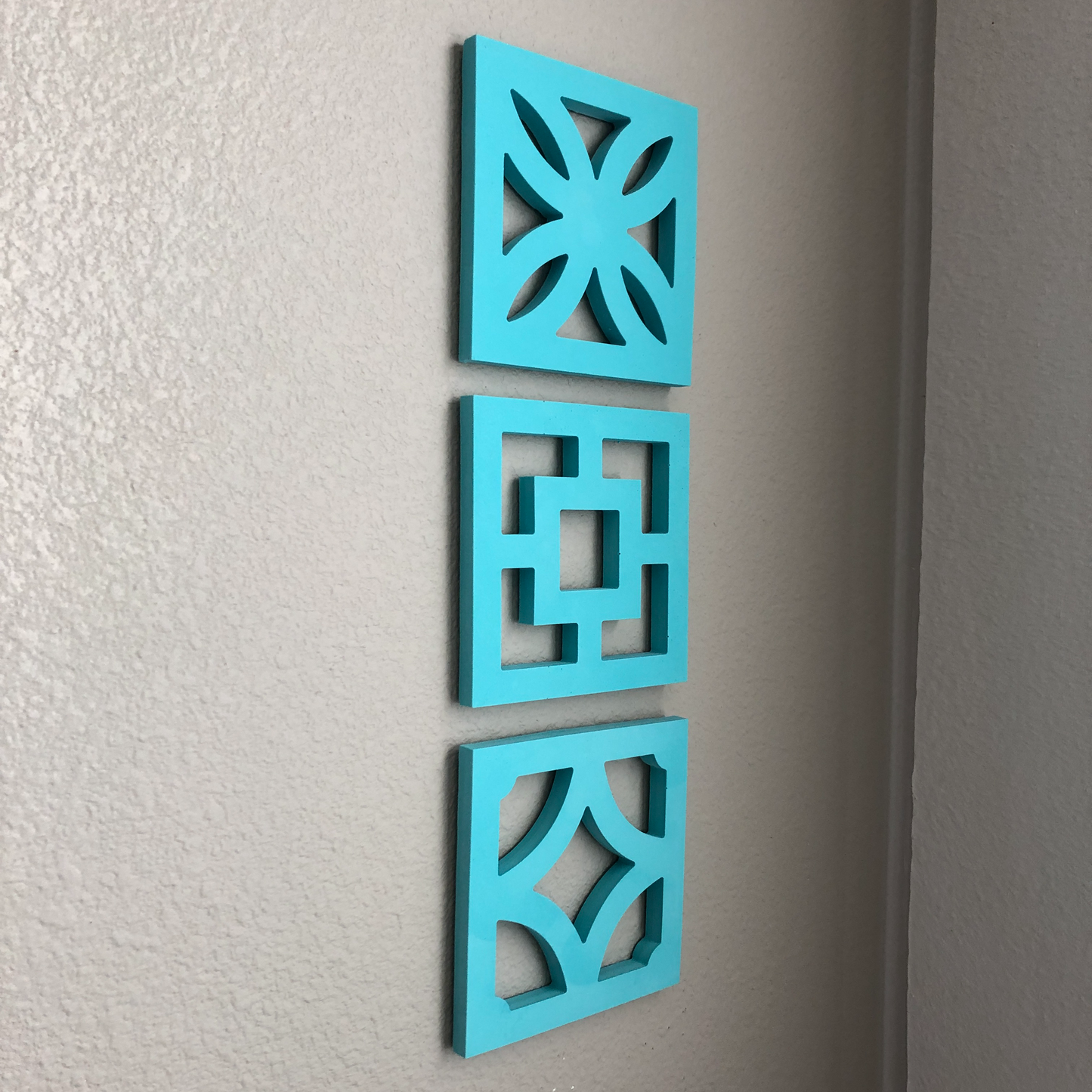 Cast urethane wall hangings. 6" x 6" x 1/2". Bright colors and durable.